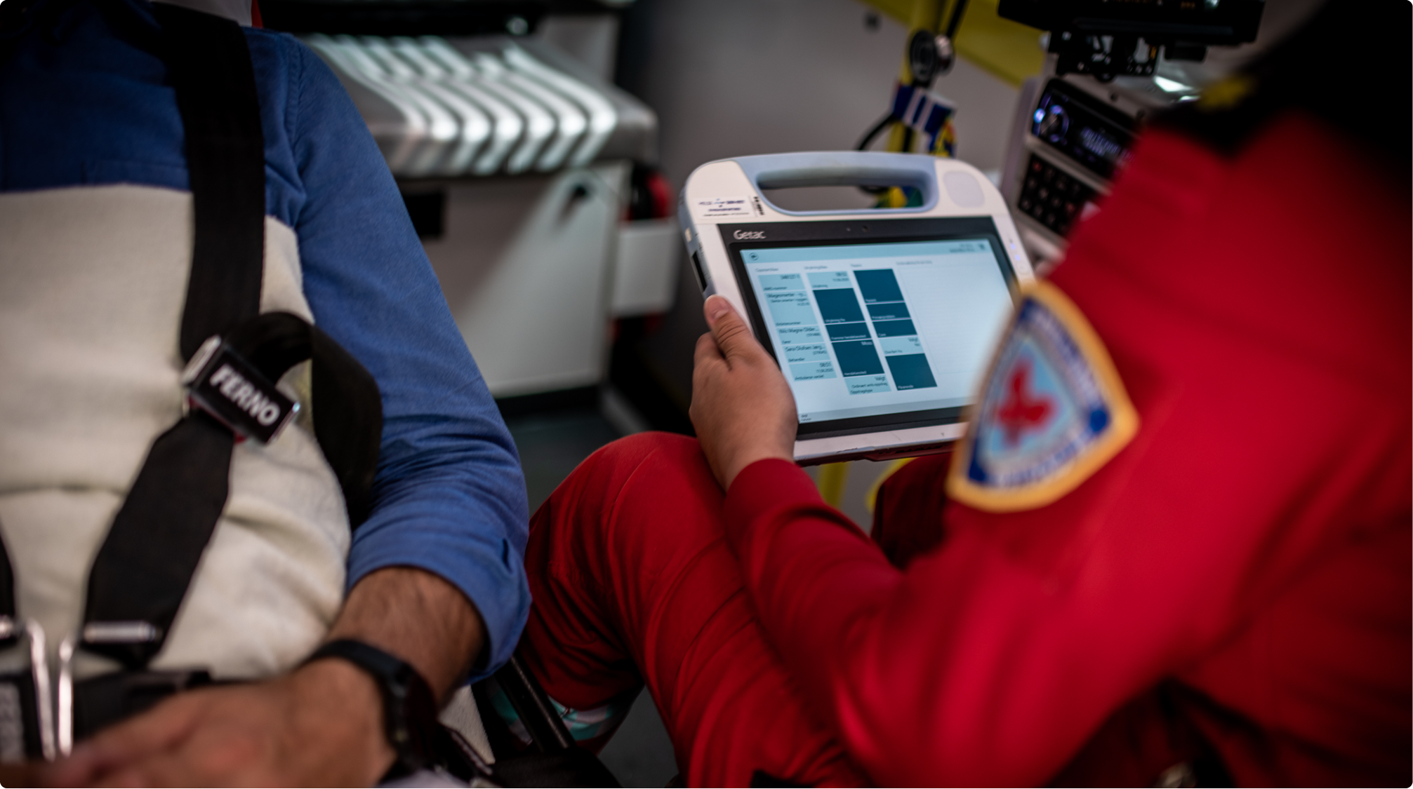 Healthcare worker in ambulance using EWA Electronic Patient Care Reporting