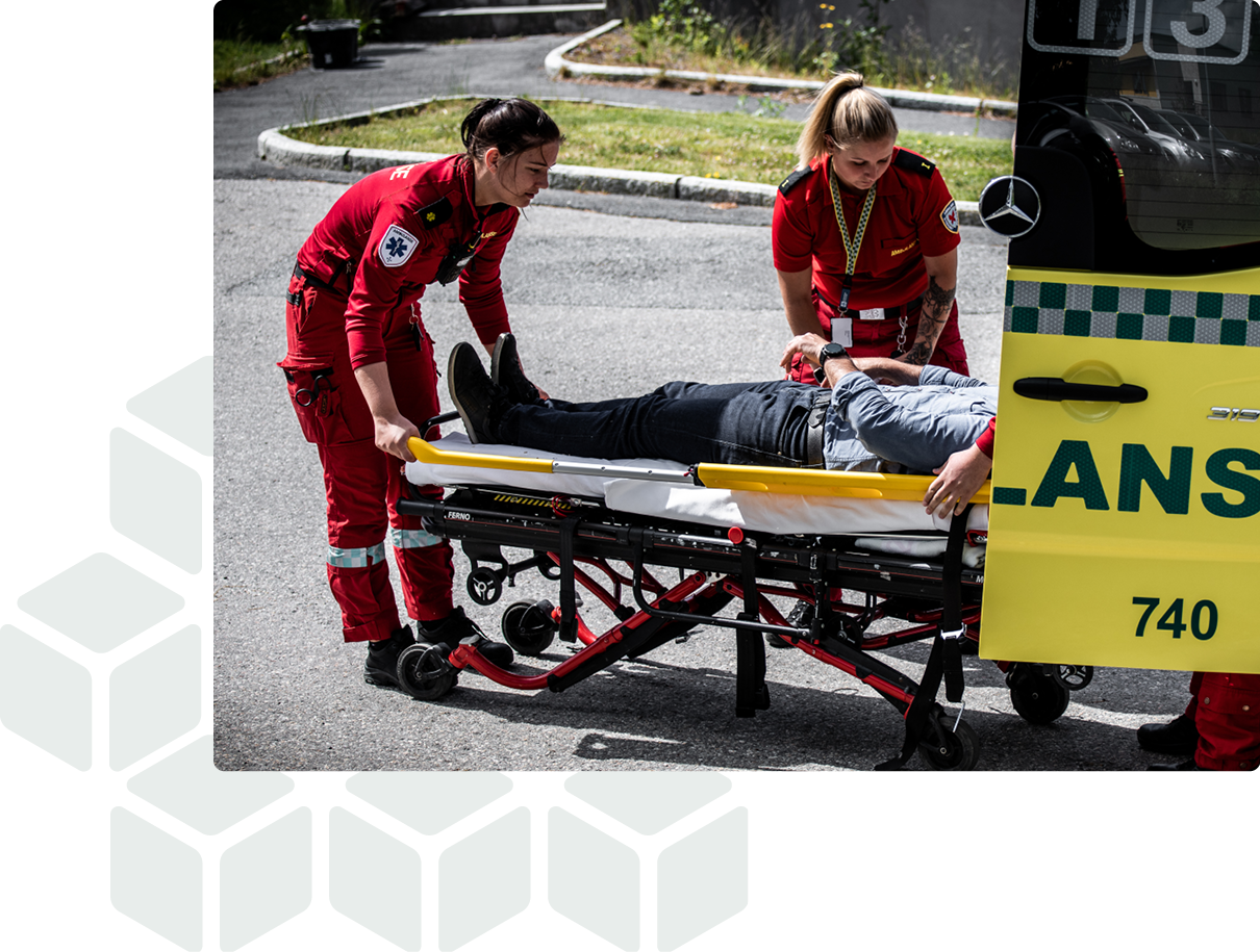 Ambulance workers help injured into an ambulance